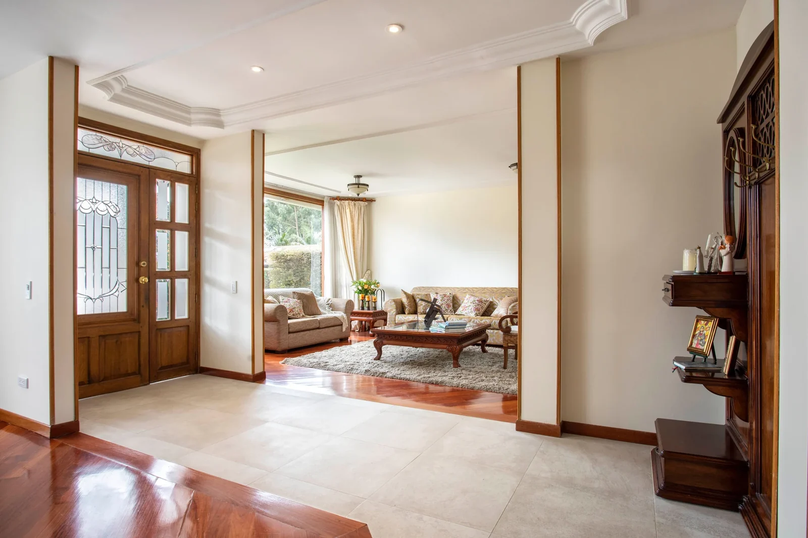 Living space with upholstered seating, a coffee table, and large windows.