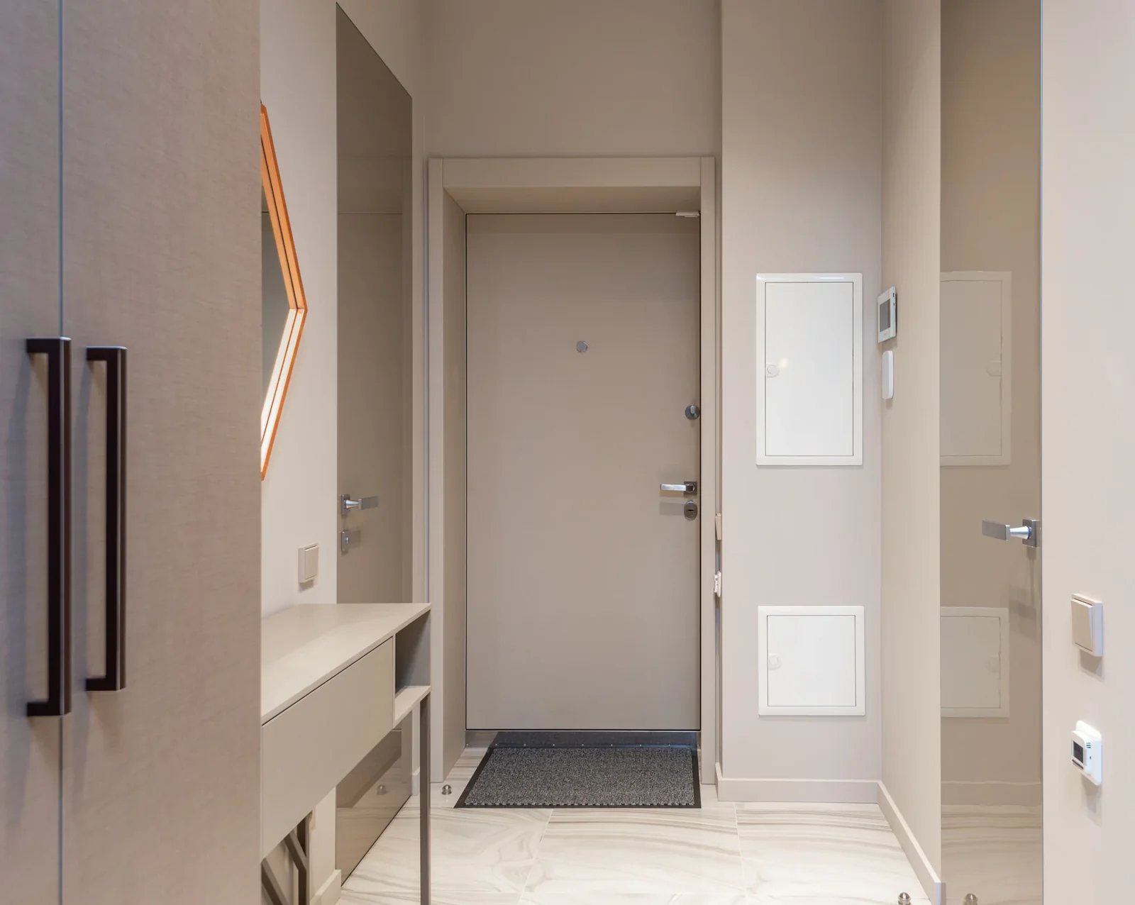 Neutral home hallway with wooden furniture, doors and a floor rug.