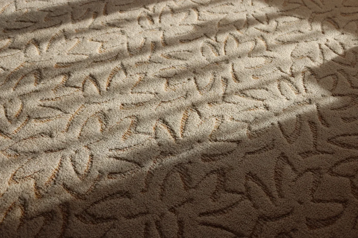 An intricately patterned beige area rug