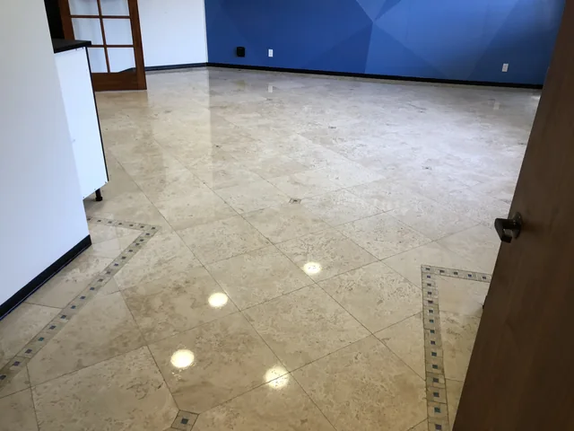 Decorative tile floor after cleaning: A brighter-looking floor with the same decorative tile insets and border.