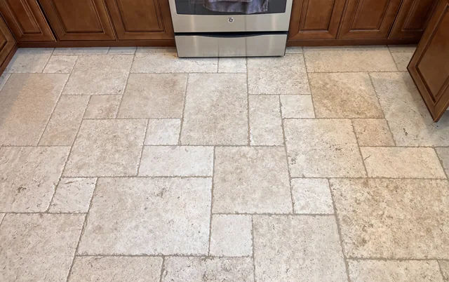 Patterned floor tile and grout after cleaning: The tile pattern looks more defined, with lighter-looking grout lines between the pieces.
