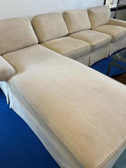 Upholstered sectional after cleaning: A fresher, more even-looking seating surface across the same sectional.