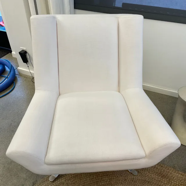 Upholstered accent chair after cleaning: A fresher-looking chair with a more even appearance across the upholstery.