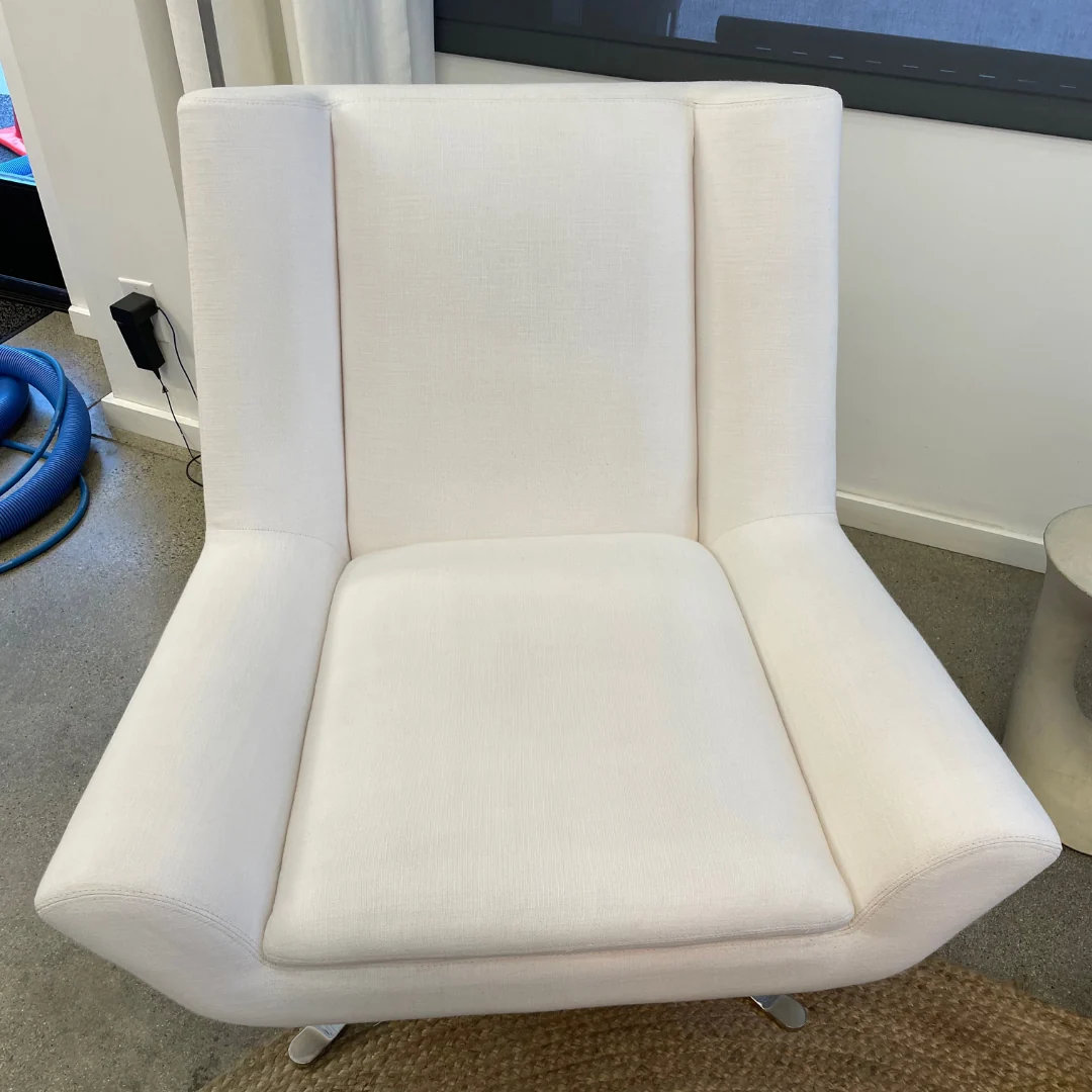 Upholstered accent chair after cleaning: A fresher-looking chair with a more even appearance across the upholstery.