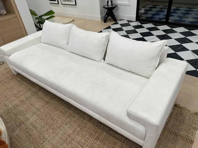 Light upholstered sofa after cleaning: The same sofa with a brighter, more even-looking seat and arms.