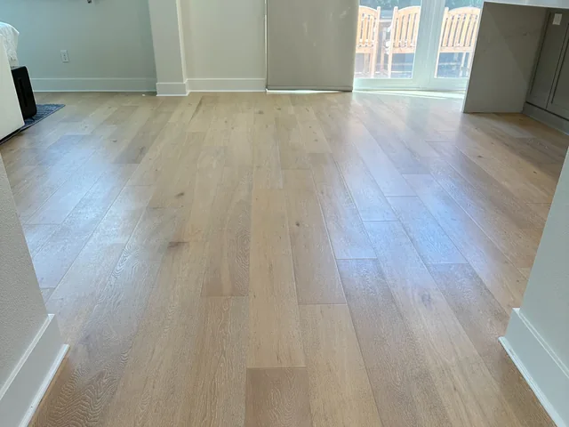 Wood-look plank flooring after cleaning: The same plank pattern with a more even-looking finish and visible reflected light.